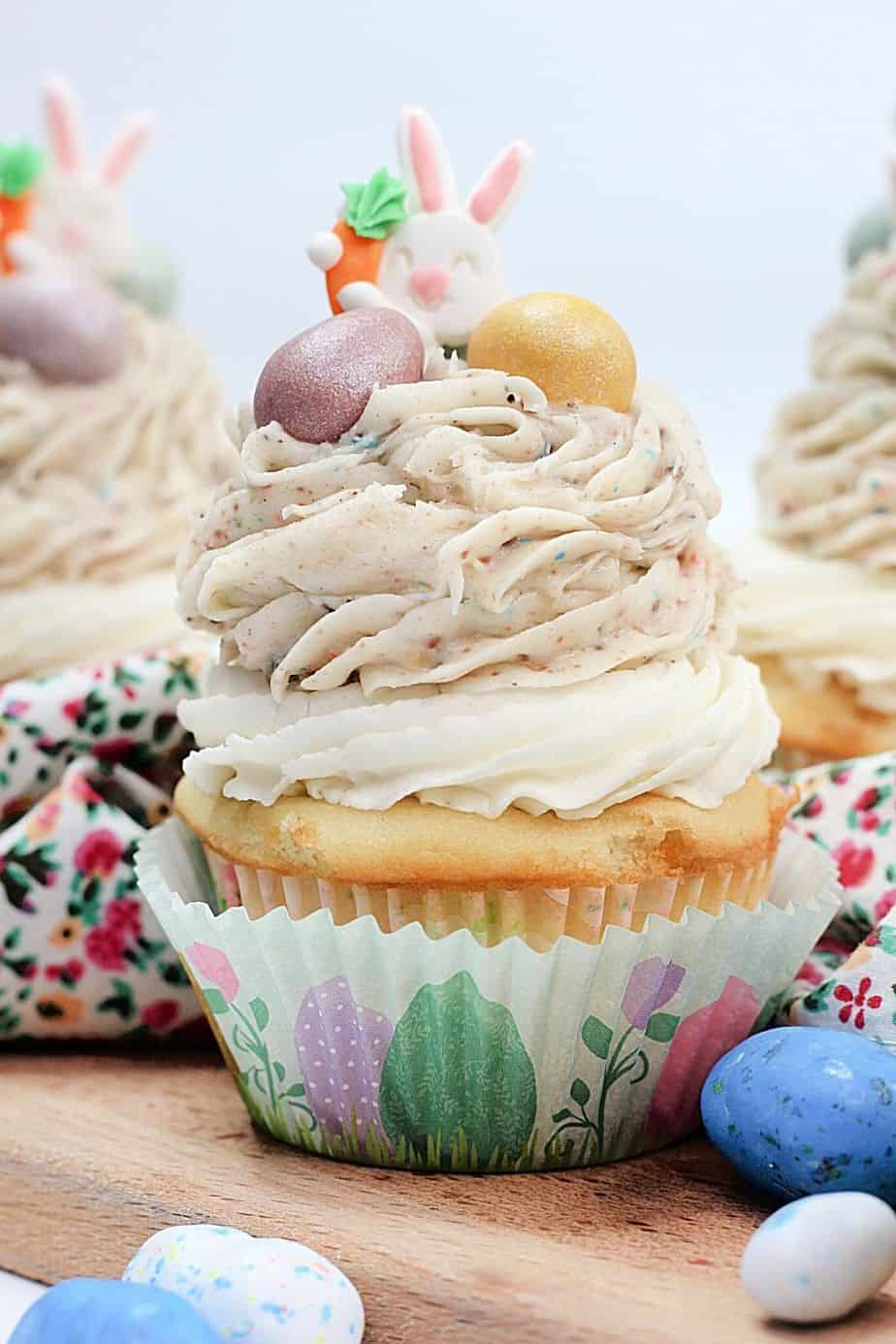 These Easter Egg Malt Cupcakes are a fun Easter cupcake recipe the whole family will enjoy. These cupcakes are easy to decorate and made with the classic malted easter eggs (or Whoppers).