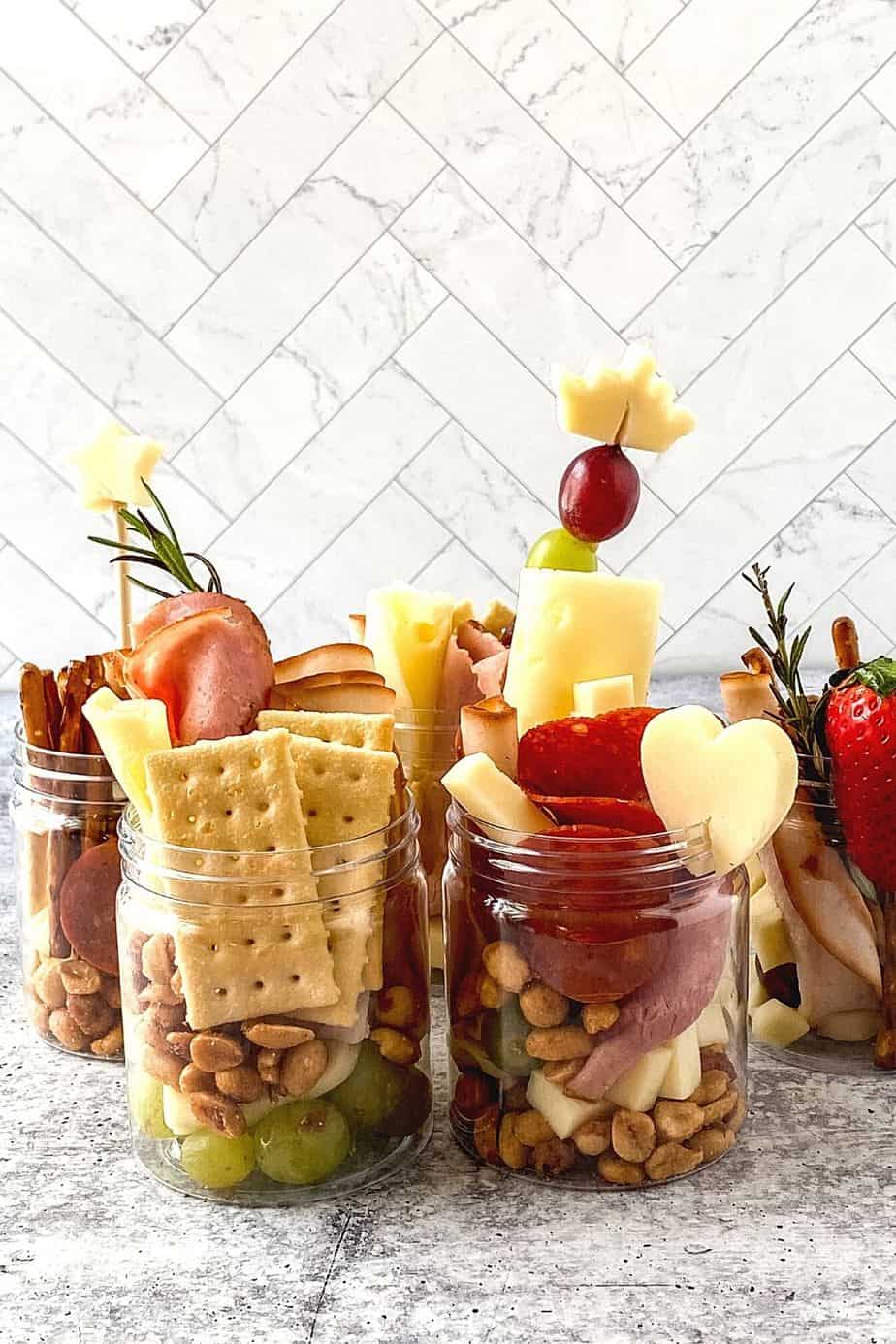 Jarcuterie Mason Jars are a fun alternative to a charcuterie board. These mason jar appetizers are individually portioned Charcuterie mason jars. They are an easy party idea to serve at your next gathering.
