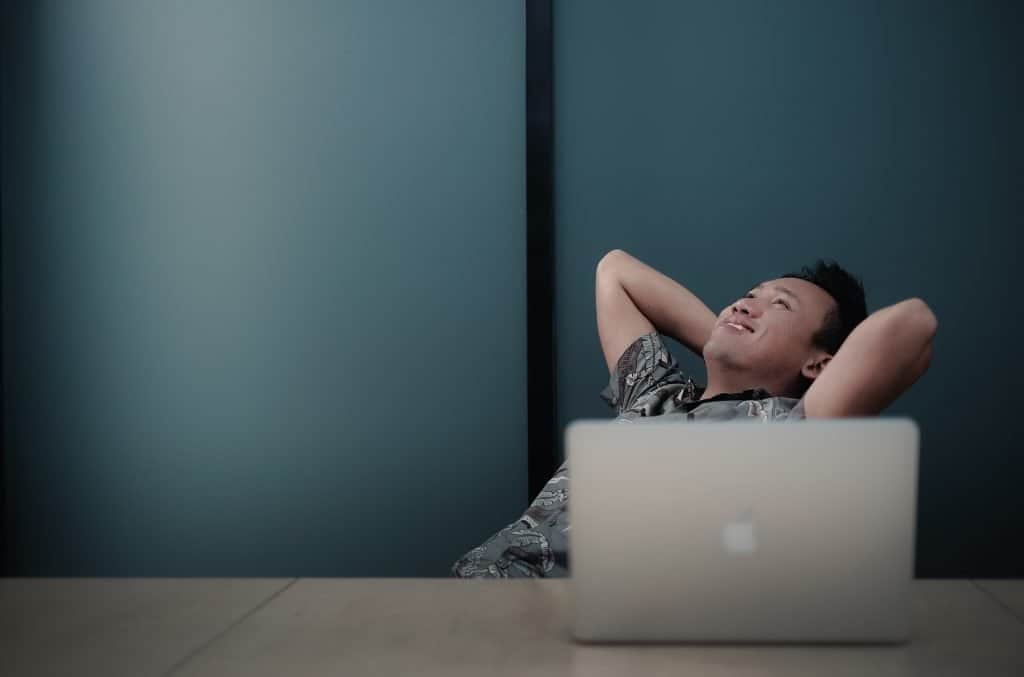 feelgood online ordering online ordering makes you feel good asain man leaning back in front of chair with laptop