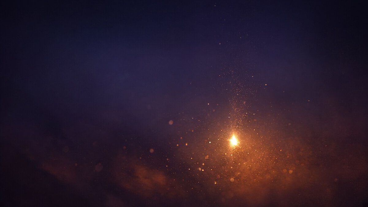A single gold ember rising in near darkness against deep indigo