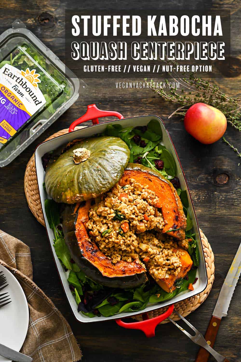 A large, roasted kabocha squash centerpiece, in a casserole dish, stuffed with a rice/tempeh mixture, on a dark background.