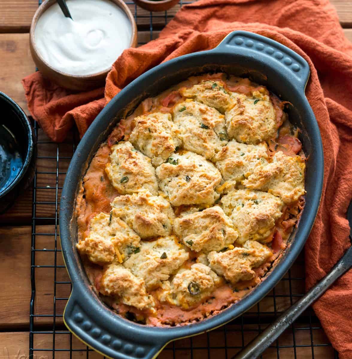 Savory Tomato Cobbler with Vegan Cheddar Chive Biscuit topping! Delicious, hearty and perfect for a weeknight dinner. #nutfree #dairyfree