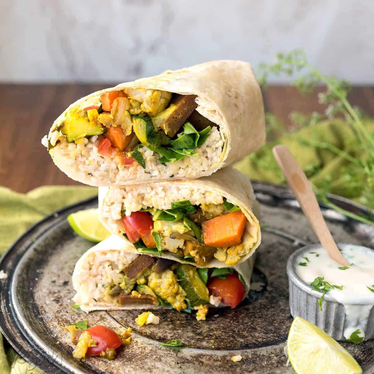 This Curry Cauliflower Burrito is easy-to-make, filled with awesome flavors, and can even be frozen for weekly lunches! Made with delicious Sweet Earth Foods’ Curry Satay. Mmm.. #vegan #nutfree #veganyackattack