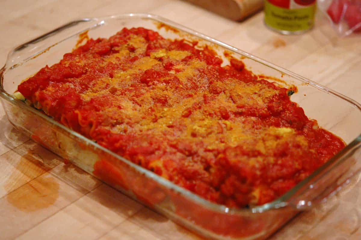 Baked Spinach and mushroom lasagna rolls in a large casserole dish