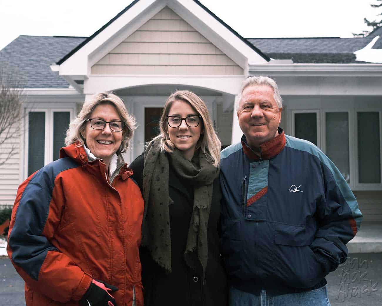 Three people pictured in front of a house in Michigan