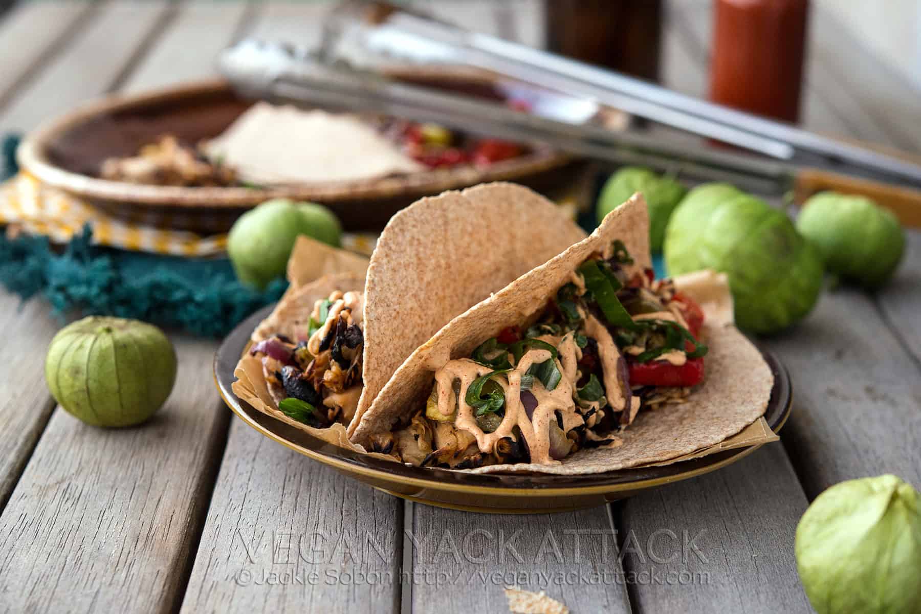 Beefy Jackfruit Tacos with grilled fajita veggies and seasoned sour cream sauce. Easy and perfect for summer! Vegan, gluten-free option
