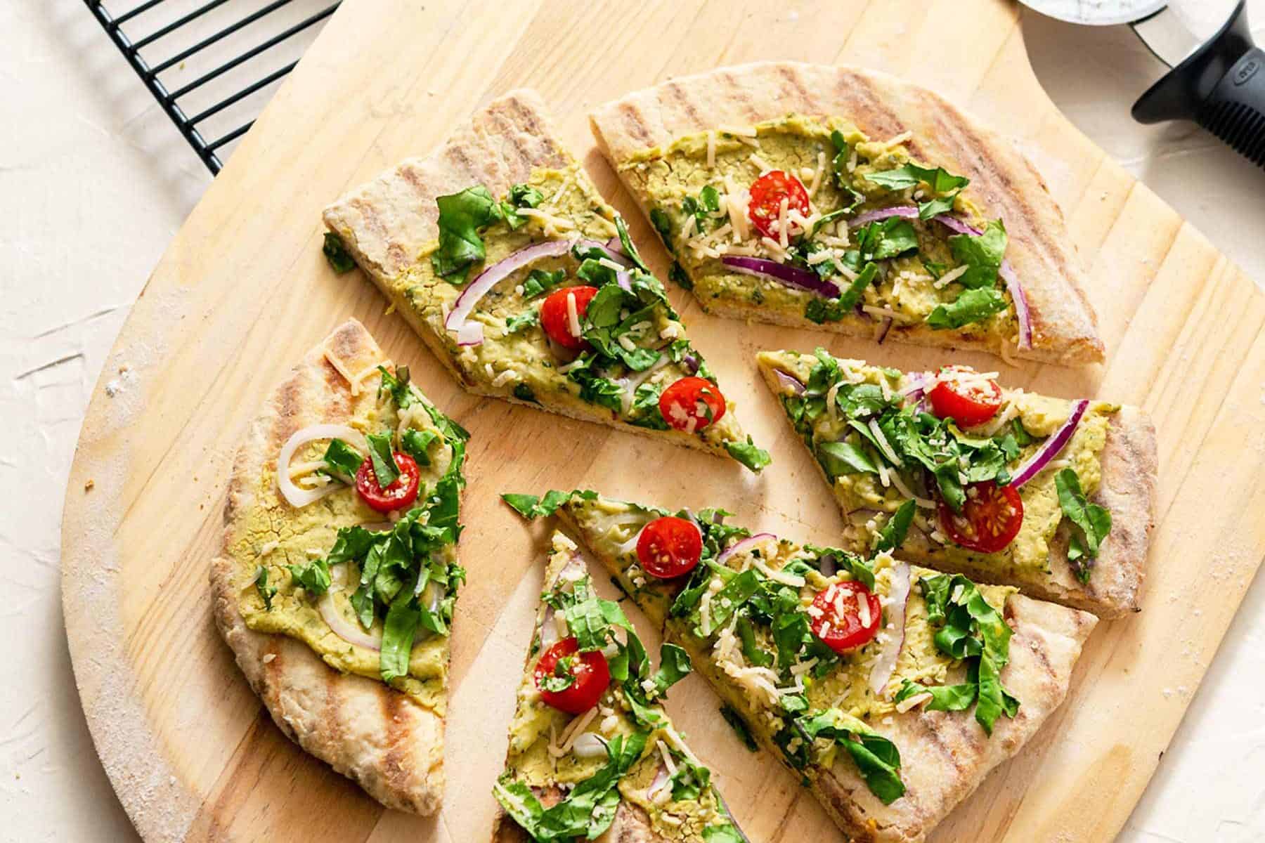 Grilled Sourdough Flatbread cut into slices on a wooden pizza peel