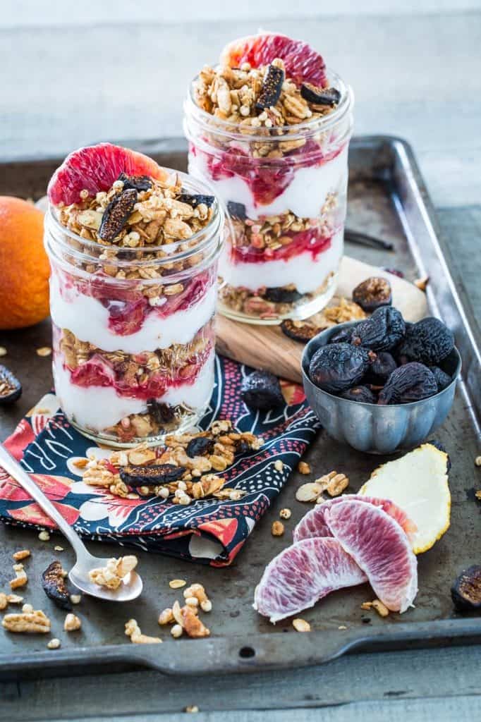 Vanilla Almond Fig Granola Parfaits with Blood Oranges in two jars on a baking sheet
