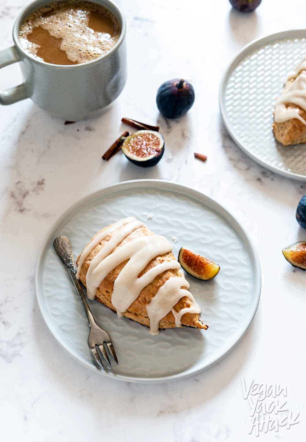 Vegan Glazed Figgy Maple Scones on two small gray plates and marble table top