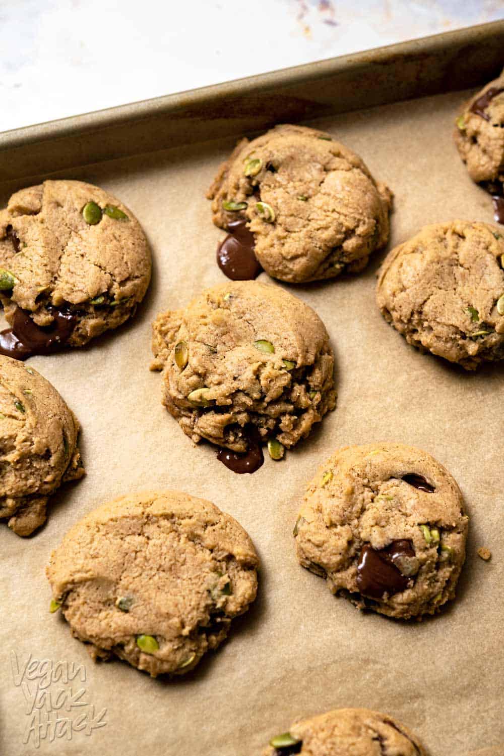 Freshly baked chocolate chai cookies on a parchment-lined baking sheet