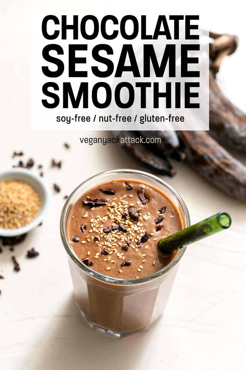 One large glass filled with chocolate sesame smoothie, with seeds, nibs, and bananas on the side