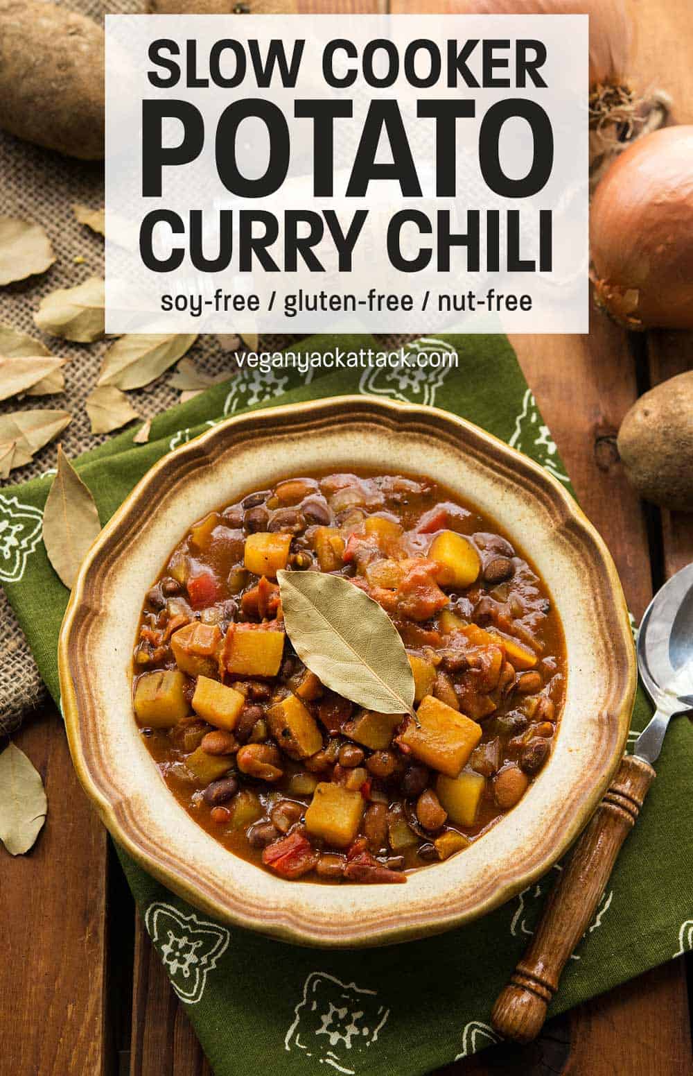 Slow Cooker Potato Curry Chili- An easy stew that fuses the flavors of curry and chili together to make one hearty, tasty meal! Vegan, Gluten-free, Soy-free Slow Cooker Potato Curry Chili in a stoneware bowl with green linen and wood table top