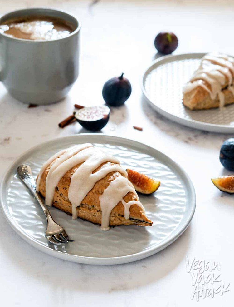 Vegan Glazed Figgy Maple Scones on two small gray plates and marble table top