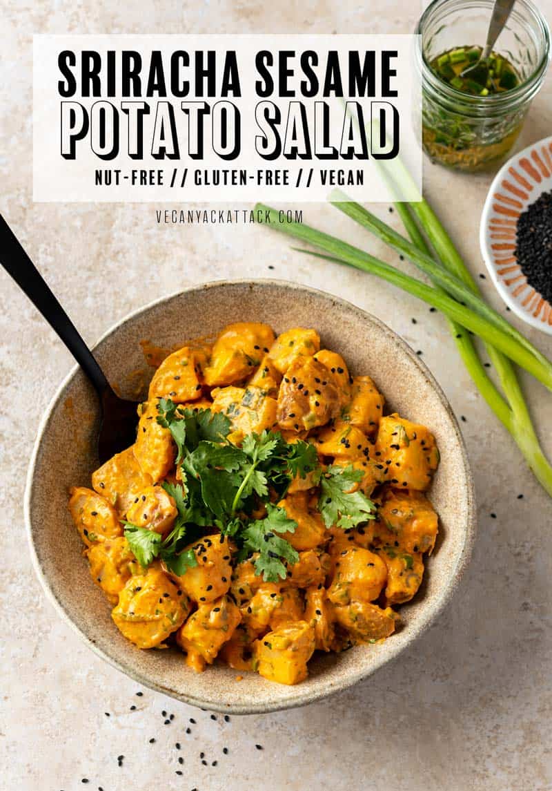 Large ceramic bowl filled with sriracha potato salad that is topped with sesame seeds and cilantro
