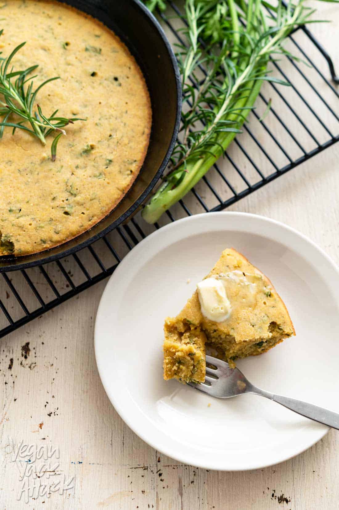 Image of Carrot Top Herb Cornbread on a cooling rack with slice cut out