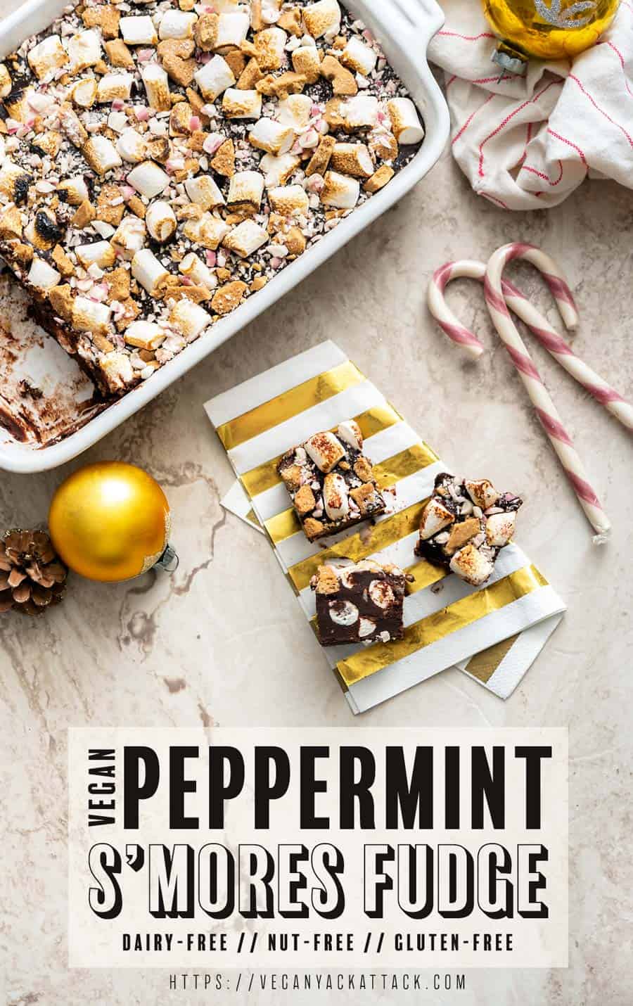 Pieces of vegan peppermint s'mores fudge cut out of the dish and on a napkin, with recipe title text