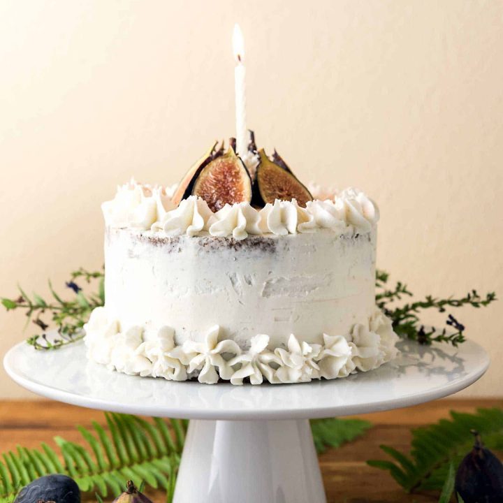 This Caramel Fig Vanilla Layer Cake has gorgeous layers of vegan buttercream, date caramel, and fluffy cake, topped with fresh figs! Soy-free, Dairy-free