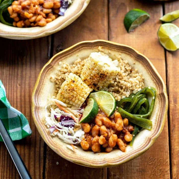 Just in time for summer, these #vegan BBQ Bean Bowls are a sampler of everything you love at a cookout! Grilled corn and pasilla peppers, coleslaw, quick bbq beans, plus, some cumin-spiced quinoa to make it a well-rounded meal. #glutenfree #plantbased