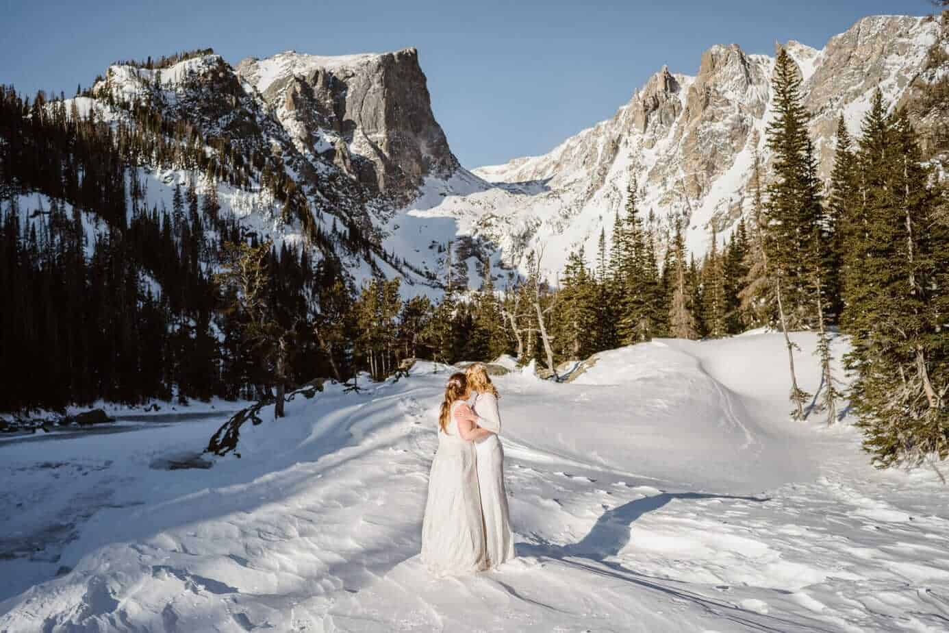 Bride and Bride Hugging Winter Elopement Guide