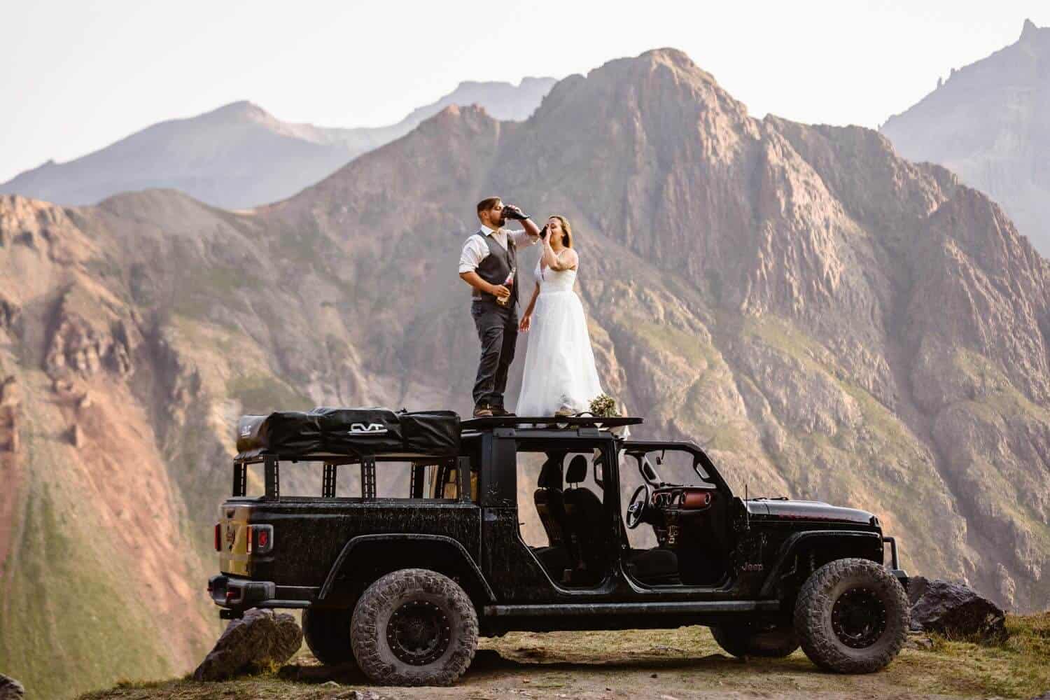 Bride and Groom Drinking Champagne Colorado Off-Roading Elopement