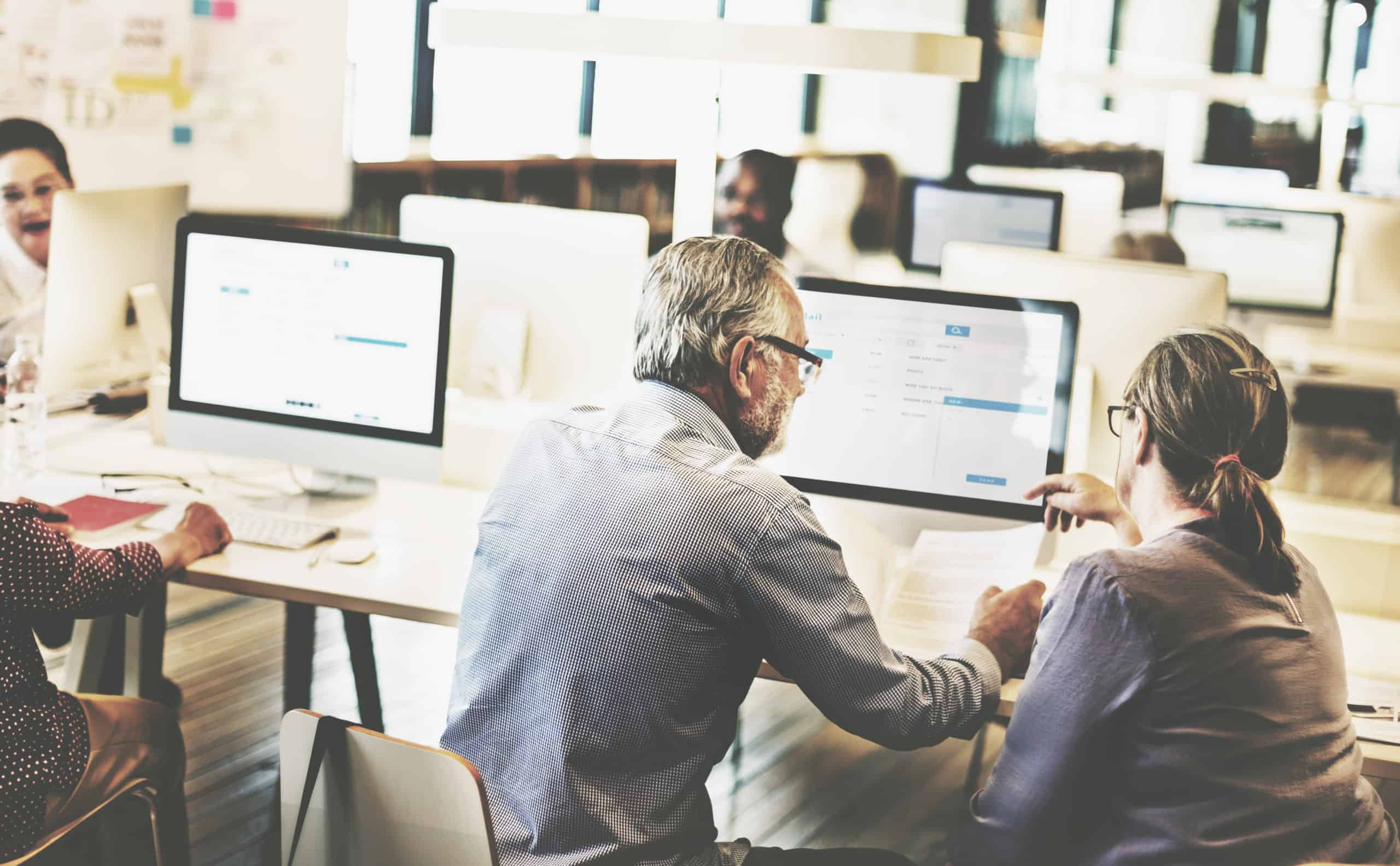 group-diverse-senior-adults-computer-class Automating in finance
