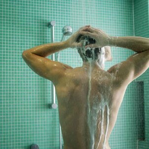 The man takes a shower