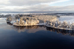 Panoramic winter landscape with lake, calm atmosphere in the Harz Mountains