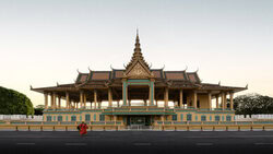 Photo art: calm capture of the Royal Palace in Cambodia with monk in the foreground.