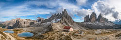 Panorama of the Dolomites in South Tyrol with gentle mountains and clouds in the sky.