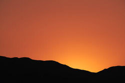 Photo art by Tal Paz-Fridman: expansive view of Eilat mountains in warm twilight light