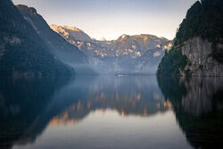 Morning scene at Lake Königssee with gentle misty clouds.