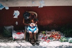 Wall art of an elderly woman selling fresh vegetables at a market in the Philippines