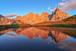 Photo art by Achim Thomae: sunset over the Dolomites with mountain lake and reflection.