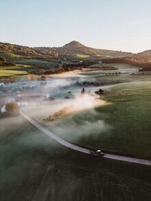 Photo art by Kerstin Maier: peaceful rural road in fog during early morning light