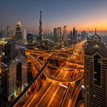 Wall art by Achim Thomae: panorama of the illuminated Dubai skyline at sunset