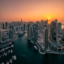 Wall art by Achim Thomae: sunset over Dubai Marina featuring skyscrapers and boats.