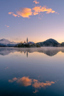 Photo art: Sunrise over Lake Bled with gentle clouds and morning mist.