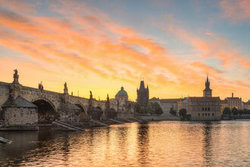 Sunrise over Prague featuring the historic Old Town Bridge Tower.