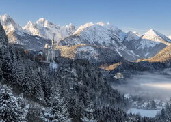 Photo art by Achim Thomae: Neuschwanstein Castle in morning mist during winter.