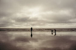 Minimalist silhouette of a family on a beach in Denmark, calm mood.