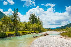 Summer day in the Isar valley featuring gentle hills and a calm river