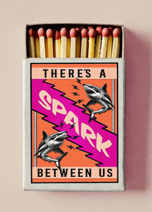 Wall art featuring a humorous quote about sharks and lighting matches.