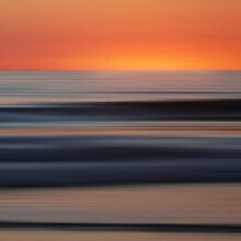 Photo art by Steffi Louis: gentle waves at the shore with a calm sunset.