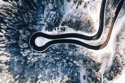 Lina Jakobi, Snow capped trees and curvy road from above