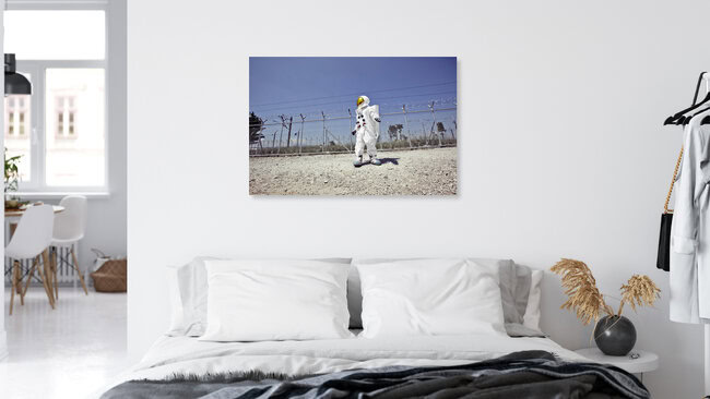 The Protestonaut in front of the border fence in Idomeni, Greece – wall art by Sophia Hauk as Poster or Acrylic Glass Print
