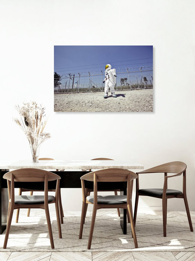 The Protestonaut in front of the border fence in Idomeni, Greece – wall art by Sophia Hauk as Poster or Acrylic Glass Print