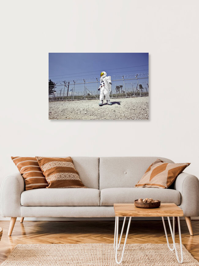 The Protestonaut in front of the border fence in Idomeni, Greece – wall art by Sophia Hauk as Poster or Acrylic Glass Print