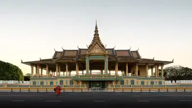 Photo art: calm capture of the Royal Palace in Cambodia with monk in the foreground.