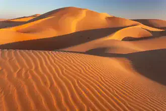 Photo art by Achim Thomae: gentle sand dunes in the Rub al Khali at sunset