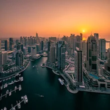 Photo art by Achim Thomae: sunset over Dubai Marina featuring skyscrapers and boats.
